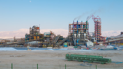 Dead Sea, Israel - June  2019: Mineral extraction plant on the shores of the Dead Sea