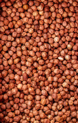 Heap of peeled hazelnuts without shell for background texture, close-up, top view, copy space for text