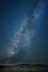 The Milky Way over a desert landscape