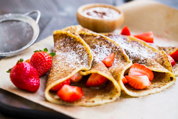 French crepes with chocolate spread and strawberries