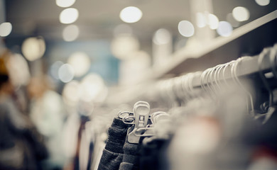 Shopping in store. Clothes on hangers in shop for sale