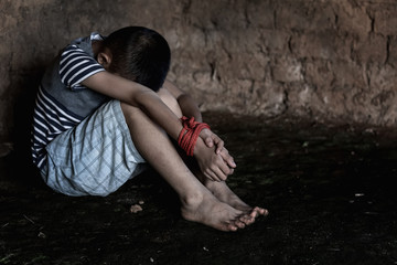 Kidnapped little boy tied with rope.Abused and tortured concept. Human trafficking concept. Stop abusing violence. © AungMyo