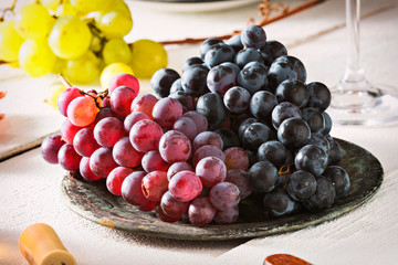 Close up of blue and red organic grapes, served on top of snack table.