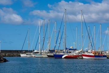 Fototapeta na wymiar Row of sail boats at Saint Pierre harbor on Réunion Island