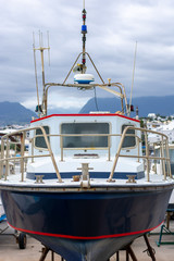 Front view of metal boat on dry harbor