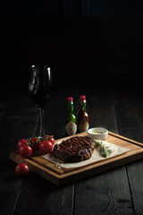 Meat steak on a wooden board. catering menu
