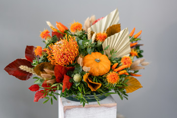 Autumn bouquet of mixed flowers on wooden table. The work of the florist at a flower shop. Fresh...