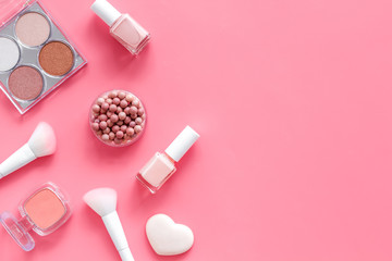 Makeup concept. Frame with decorative cosmetics and brushes on pink background top view copy space