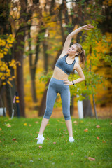 Fitness. Athlete girl, thlete exercise at outside, woman fitness. Young Beautiful Woman Stretching In The Park