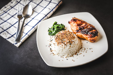 Grill chicken breast and rice with sesame on top