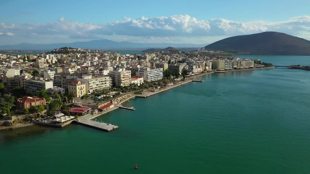 Aerial drone video of iconic town of Halkida or Chalkida with famous old bridge connecting Evoia island with mainland and beautiful clouds, Greece