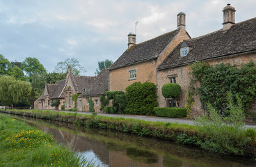 LOWER SLAUGHTER, COTSWOLDS, GLOUCESTERSHIRE, ENGLAND - MAY, 27 2018: Typical Cotswold cottages on the River Eye, Lower Slaughter, Gloucestershire, Cotswolds, England, UK