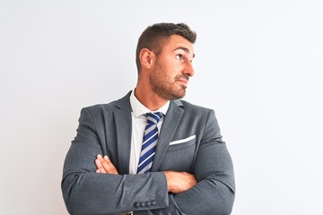 Young handsome business man wearing suit and tie over isolated background looking to the side with...