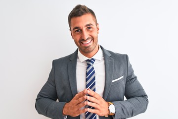Young handsome business man wearing suit and tie over isolated background Hands together and fingers crossed smiling relaxed and cheerful. Success and optimistic