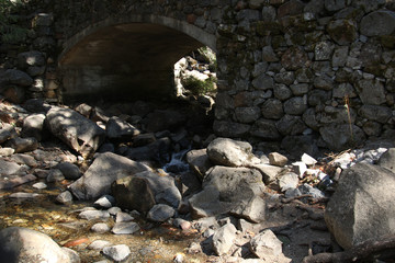 Old stone bridge across a small mountain stream