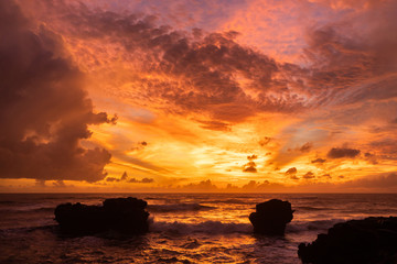 Amazing colorful bright tropical sunset in Bali island. Red colored clouds.
