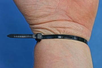 one black plastic coupler on a hand on a blue background