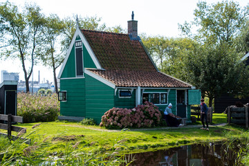 Zaanse Schans, Netherlands - 1 October 2019: Tourists sightseeng traditional Dutch rural houses in Zaanse Schans, is a typical small village within Amsterdam area.