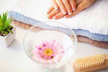 Nails care. Beautiful woman's nails with french manicure, in beauty studio