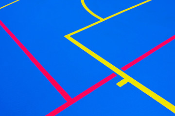 Design of a sports field, with blue background and red and yellow white lines creating strange straight lines and curves, to use with copy space.
