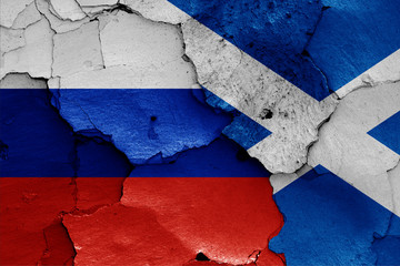 flags of Russia and Scotland painted on cracked wall