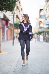 Young beautiful girl wearing sweater walking at street town