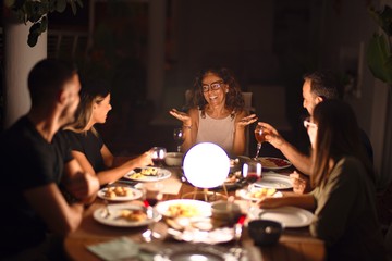 Beautiful family on dinner talking and smiling at terrace