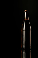 glass bottle of beer isolated on black