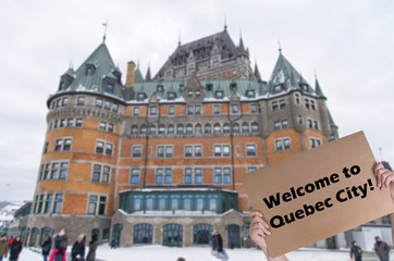 Welcome to Quebec city concept with Chateau Frontenac in the blurred background