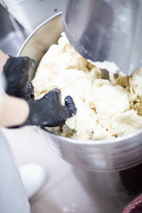 Machine kneading dough. The cook prepares the ingredients for the dish.