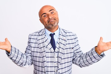 Middle age businessman wearing suit standing over isolated white background clueless and confused...
