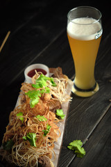 Glass of cold beer with appetizer. catering menu