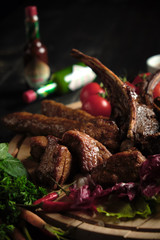 Meat on the bone on a wooden board . catering menu