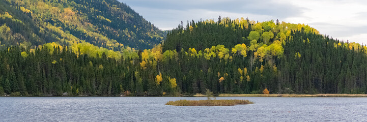 A lake in the forest in Canada, during the Indian summer, beautiful colors of the trees