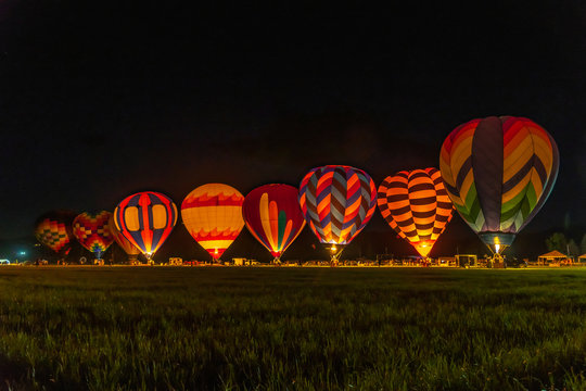 Hot air balloons during a night glow at a balloon festival in Grants Pass Oregon