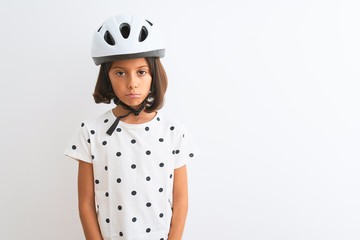 Beautiful child girl wearing security bike helmet standing over isolated white background depressed and worry for distress, crying angry and afraid. Sad expression.