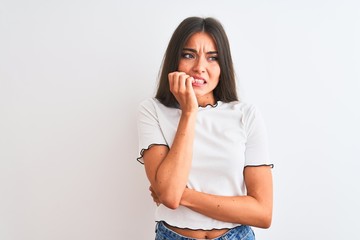 Young beautiful woman wearing casual t-shirt standing over isolated white background looking...