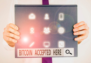 Text sign showing Bitcoin Accepted Here. Business photo text you can purchase things through Cryptocurrencies Male human holding thick textured cardboard of business promotion concept