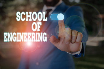 Text sign showing School Of Engineering. Business photo text college to study mechanical communication subjects Male human wear formal work suit presenting presentation using smart device