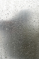 Shiny, metallic background, covered with water drops. Texture of water on a metal surface.