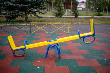 playground in the park swings, slides of a building of different colors for children's games