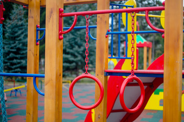 Fototapeta na wymiar playground in the park swings, slides of a building of different colors for children's games