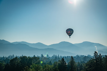 Colorful hot air balloon over Grants Pass Oregon on a beautiful summer morning