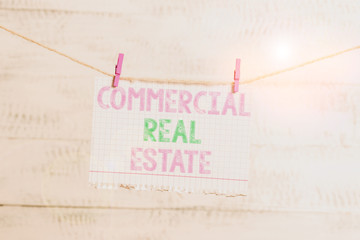 Writing note showing Commercial Real Estate. Business concept for Income Property Building or Land for Business Purpose Clothesline clothespin rectangle shaped paper reminder white wood desk