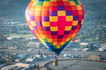 Colorful hot air balloon over Grants Pass Oregon on a beautiful summer morning