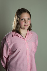 Fototapeta premium eleven year old girl in oversized pink blouse