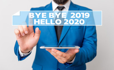 Handwriting text Bye Bye 2019 Hello 2020. Conceptual photo Starting new year Motivational message 2019 is over Businessman with pointing finger in front of him © A