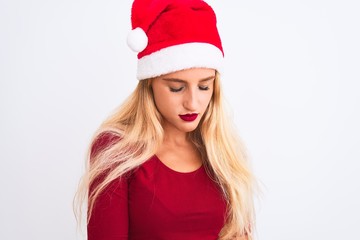 Young beautiful woman wearing Christmas Santa hat over isolated white background with hand on stomach because nausea, painful disease feeling unwell. Ache concept.