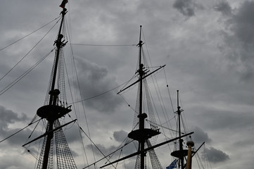 Sailing Ship's Rigging Silhouette Against Cloudy Sky at Dusk