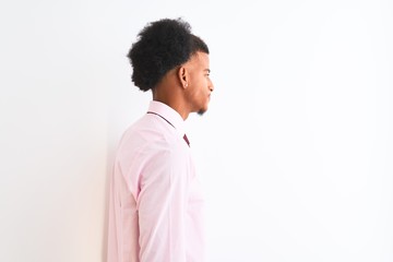 Young african american businessman wearing tie standing over isolated white background looking to side, relax profile pose with natural face with confident smile.